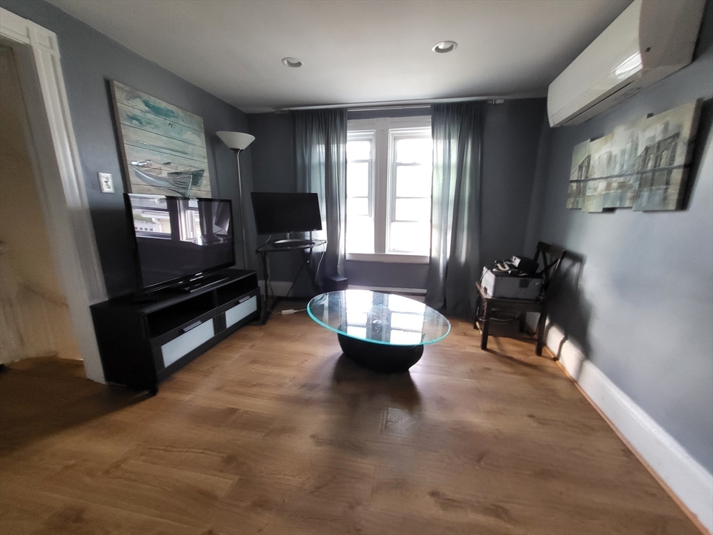 315 Main Street Everett, MA 02149 - Photo 32 of 37 a living room with furniture and a flat screen tv