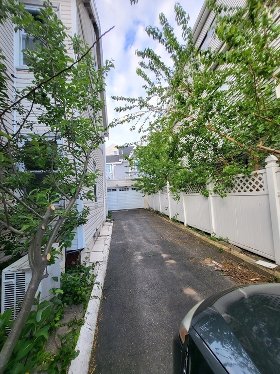 315 Main Street Everett, MA 02149 - Photo 35 of 37 a view of a backyard that has plants and large trees