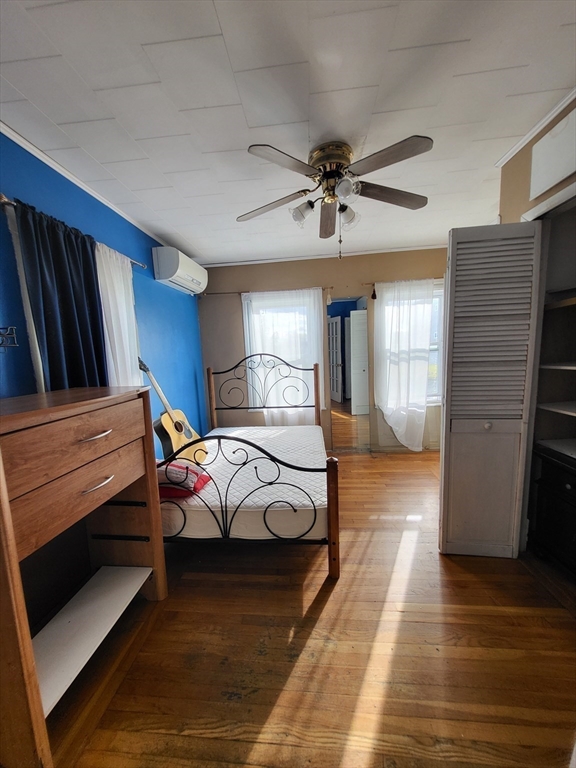 315 Main Street Everett, MA 02149 - Photo 8 of 37 a bedroom with a bed and wooden floor