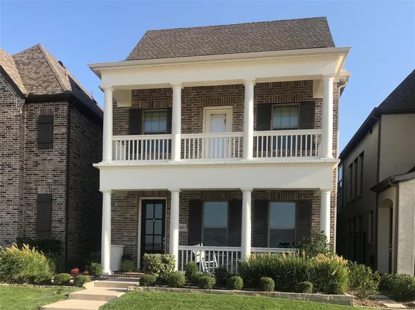 a view of a brick house with a yard