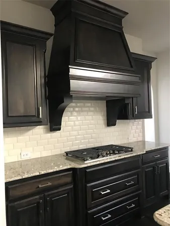 a kitchen with kitchen island stainless steel appliances a sink cabinets and microwave