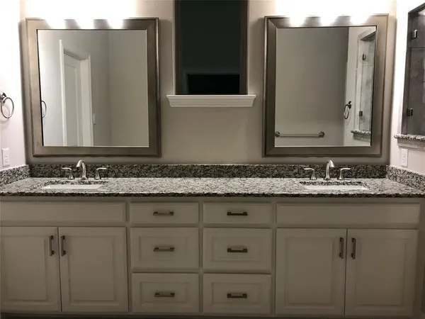 a bathroom with a glass shower door