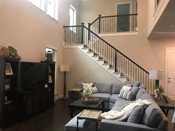 a living room with furniture and wooden floor