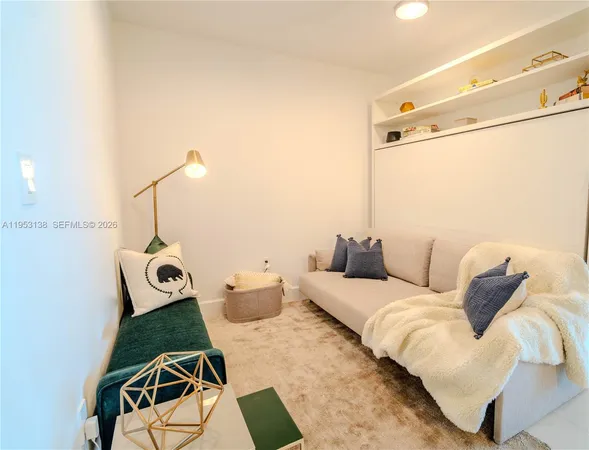 a bed room with furniture and a lamp