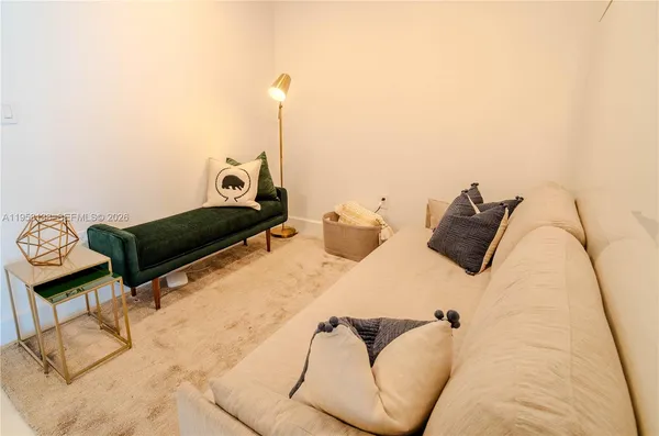 a large bed sitting in a bedroom next to a window