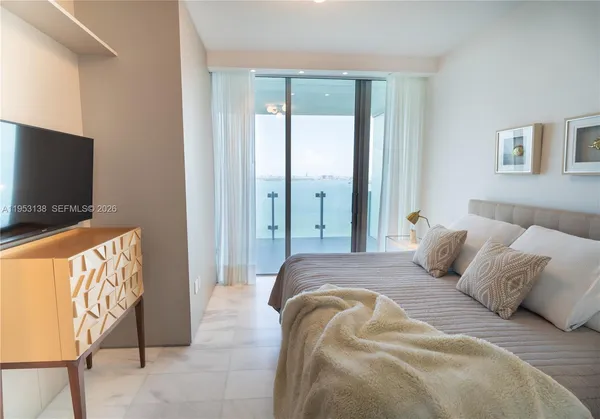 a bedroom with a bed and a couch