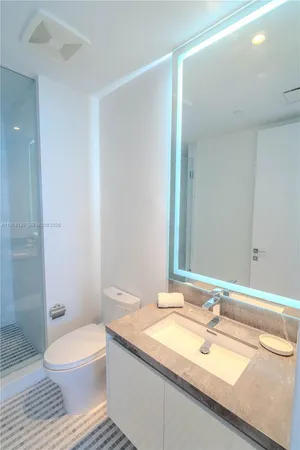 a bedroom with a bed and flat screen tv