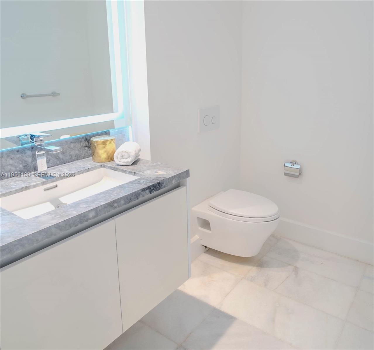 700 Northeast 26th Terrace, Unit 2602 Miami, FL 33137 - Photo 6 of 43 a bathroom with a granite countertop sink a toilet and a mirror