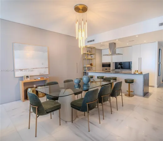 a living room with furniture a chandelier and a large mirror