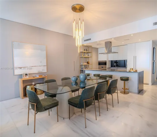 a living room with furniture a chandelier and a large mirror