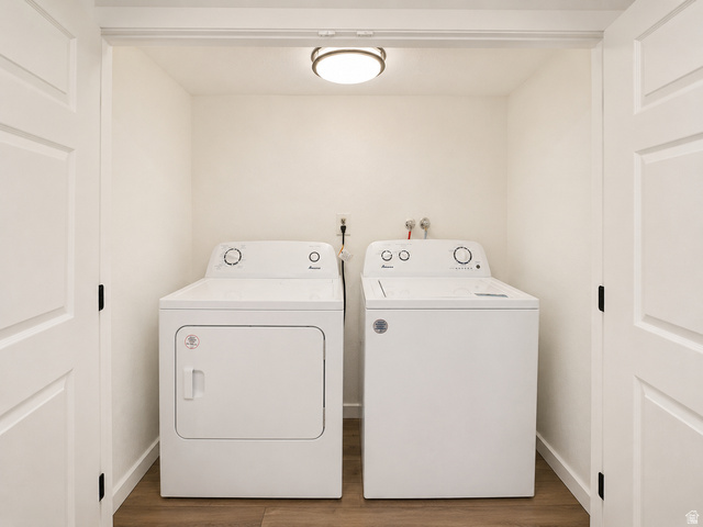 30 West 7500th Street South, Unit 18 Midvale, UT 84047 - Photo 11 of 14 Dedicated laundry closet with wood-finish flooring, included washer and dryer, ceiling-mounted light fixture, and bifold paneled doors