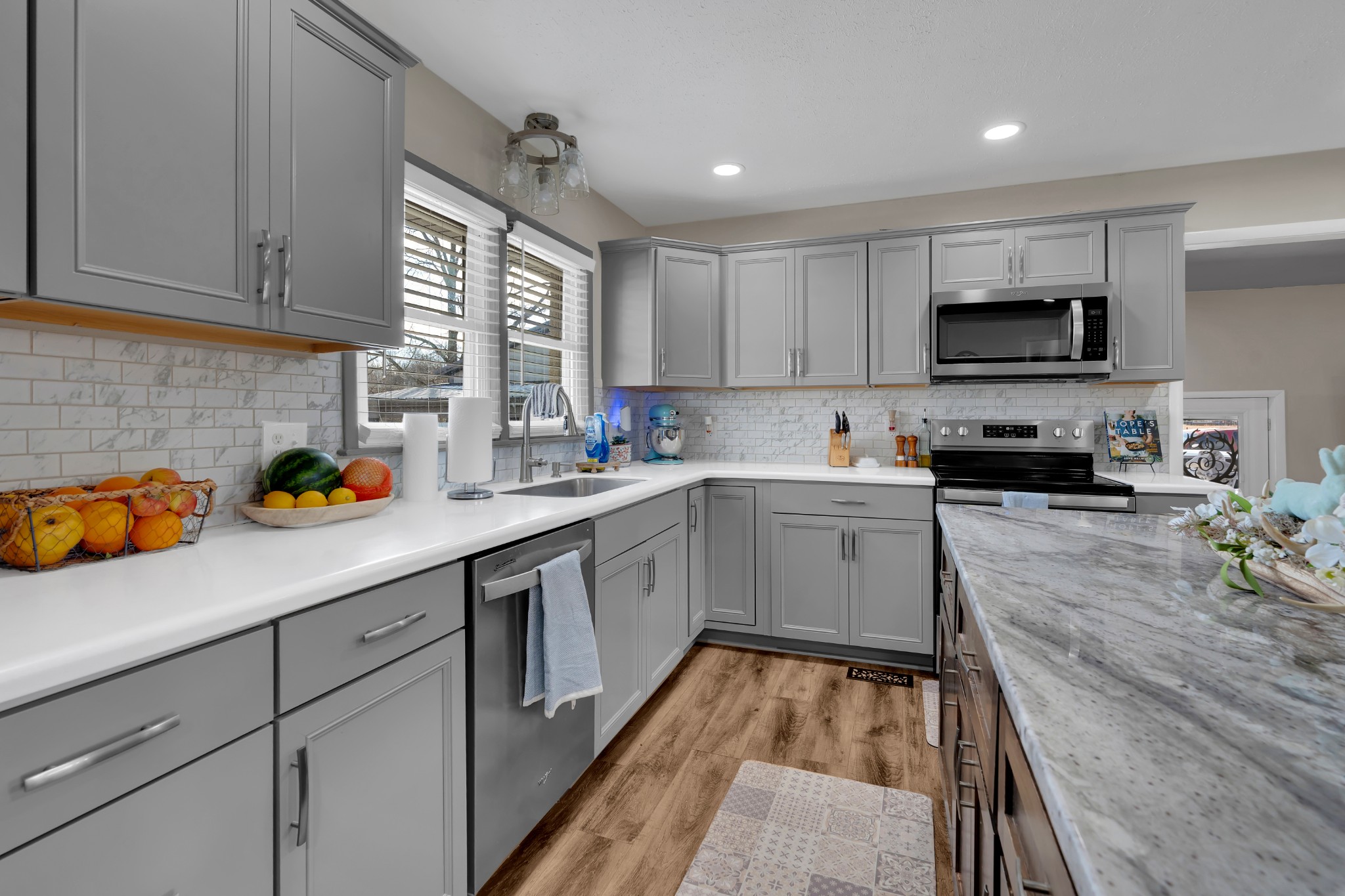 52 Hotel Road Flintville, TN 37335 - Photo 11 of 48 a kitchen with a sink dishwasher a stove and a microwave oven with cabinets