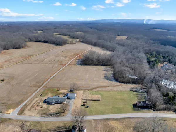 a kitchen with granite countertop a refrigerator stove top oven and cabinets