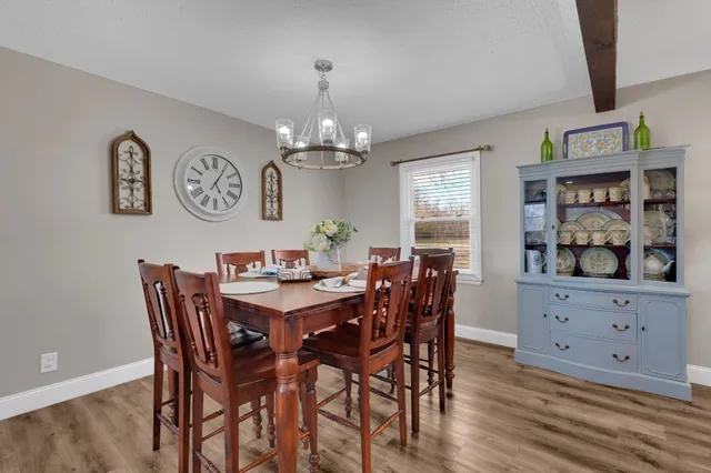 a view of a dining room with furniture and chandelier