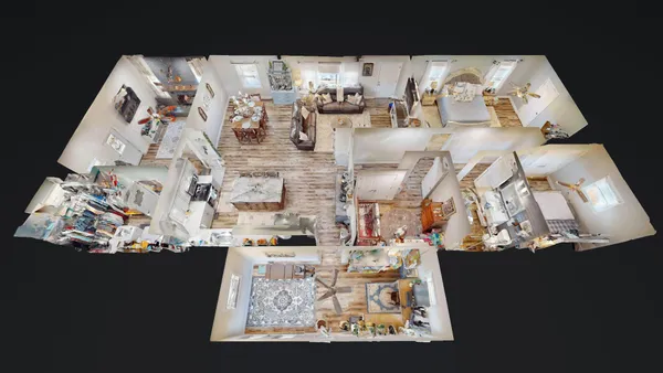 a living room with furniture and a view of kitchen