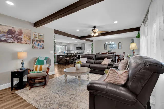 a kitchen with lots of wooden furniture a sink appliances and cabinets