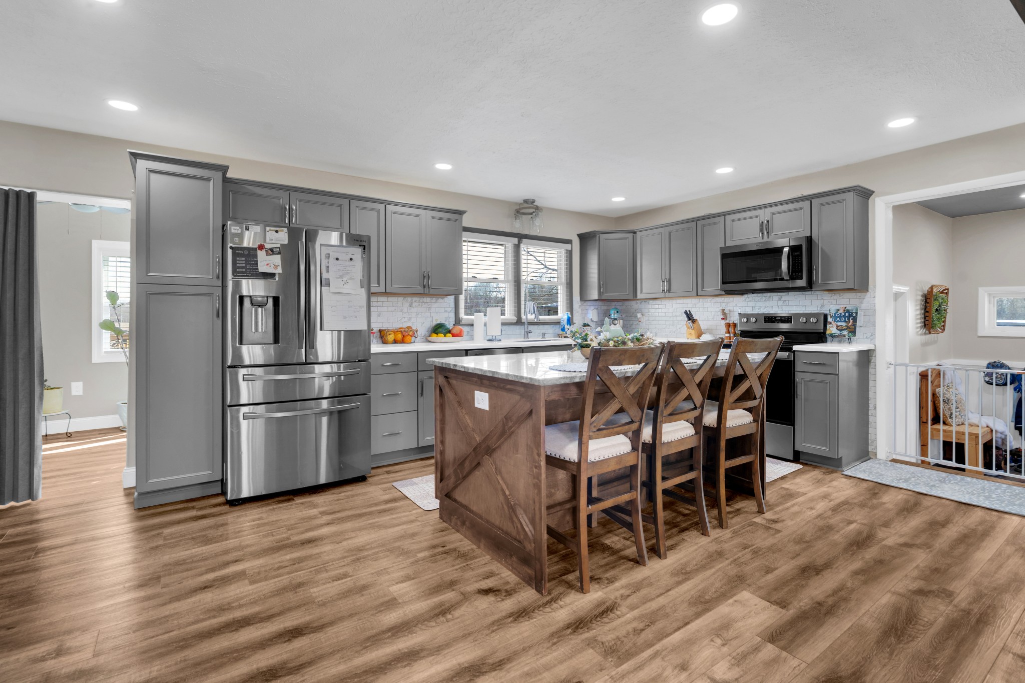 52 Hotel Road Flintville, TN 37335 - Photo 8 of 48 a kitchen with stainless steel appliances a refrigerator a stove a sink a dining table and chairs