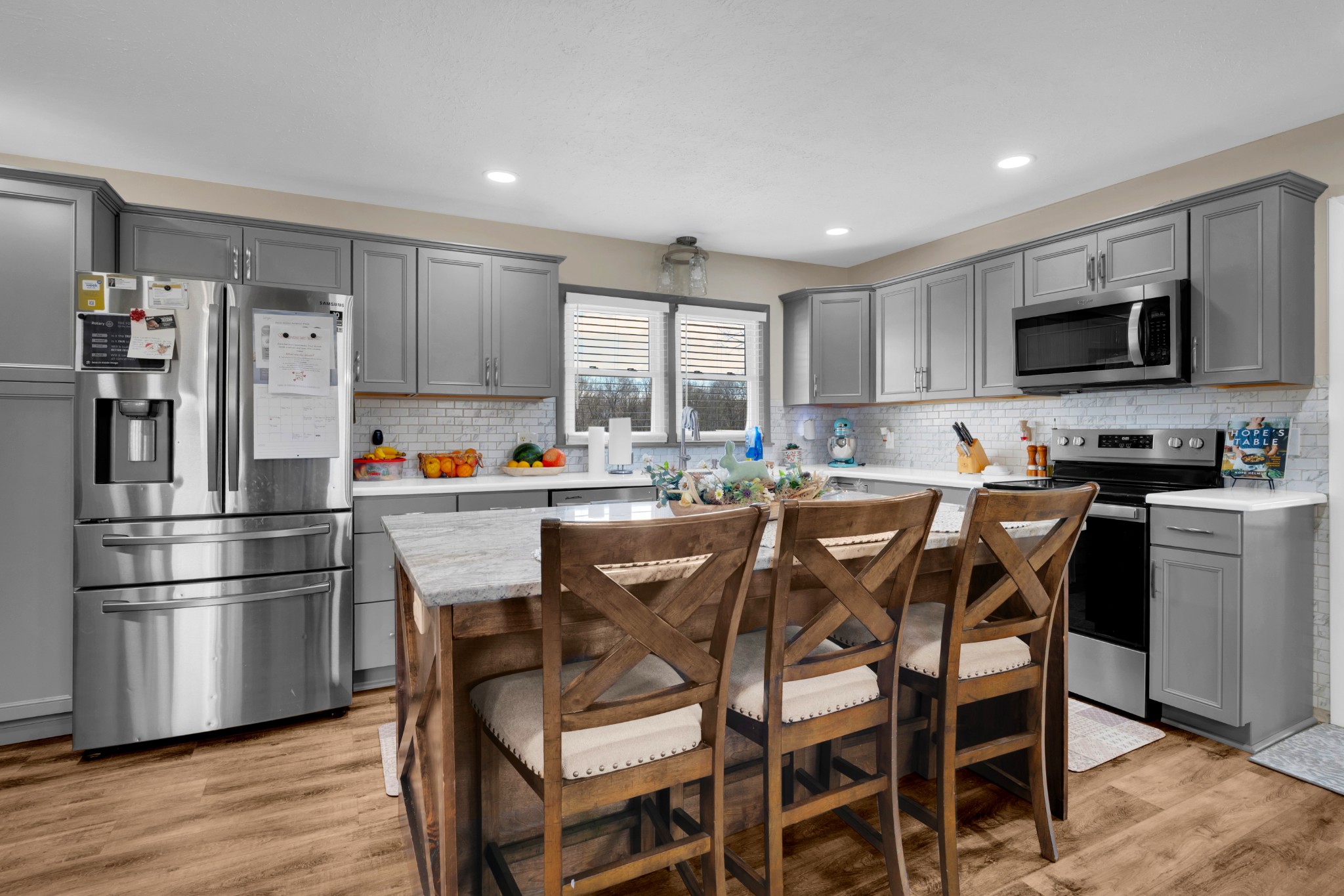 52 Hotel Road Flintville, TN 37335 - Photo 9 of 48 a kitchen with a table chairs refrigerator and microwave
