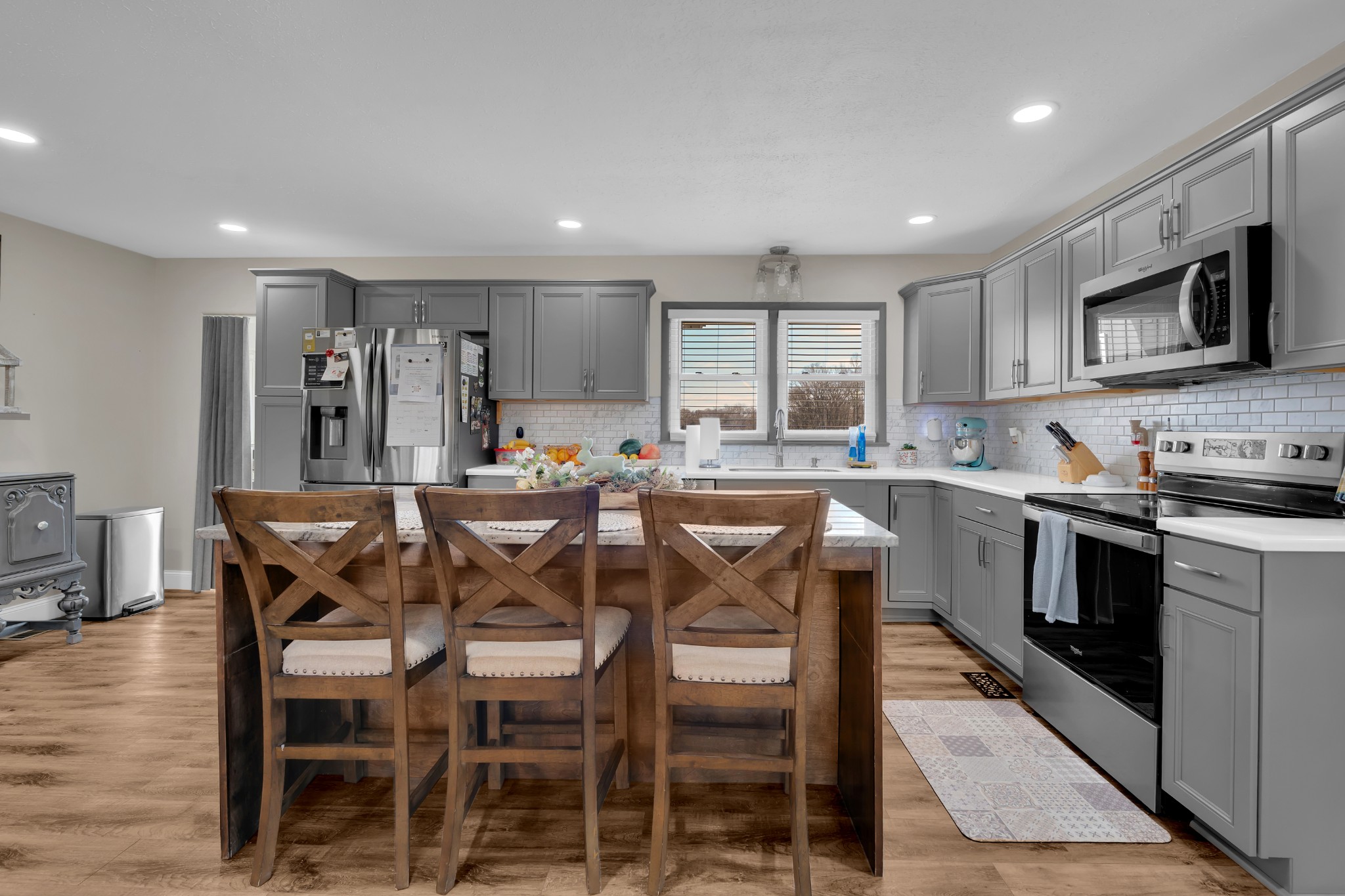 52 Hotel Road Flintville, TN 37335 - Photo 10 of 48 a kitchen with stainless steel appliances granite countertop a stove a sink a microwave a island with a dining table and chairs
