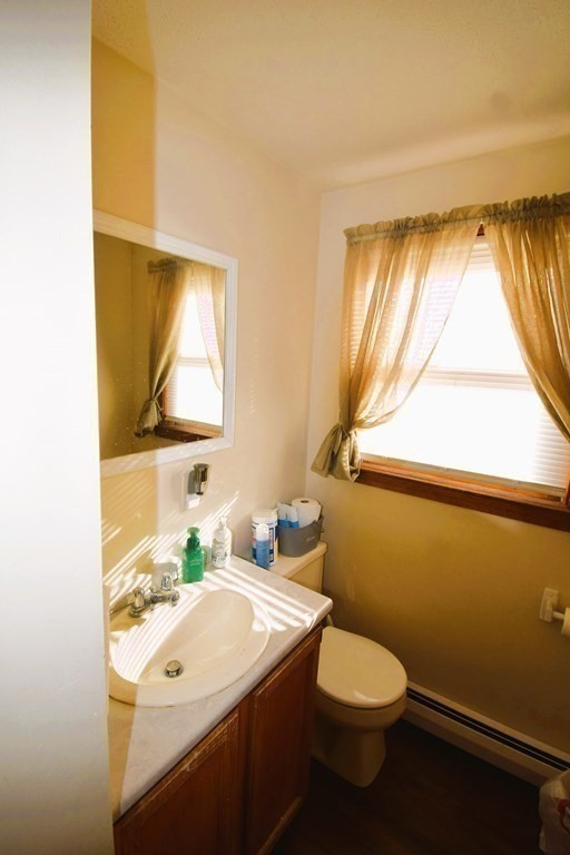 230 Chester Road Fremont, NH 03044 - Photo 13 of 30 a bathroom with a sink toilet and window