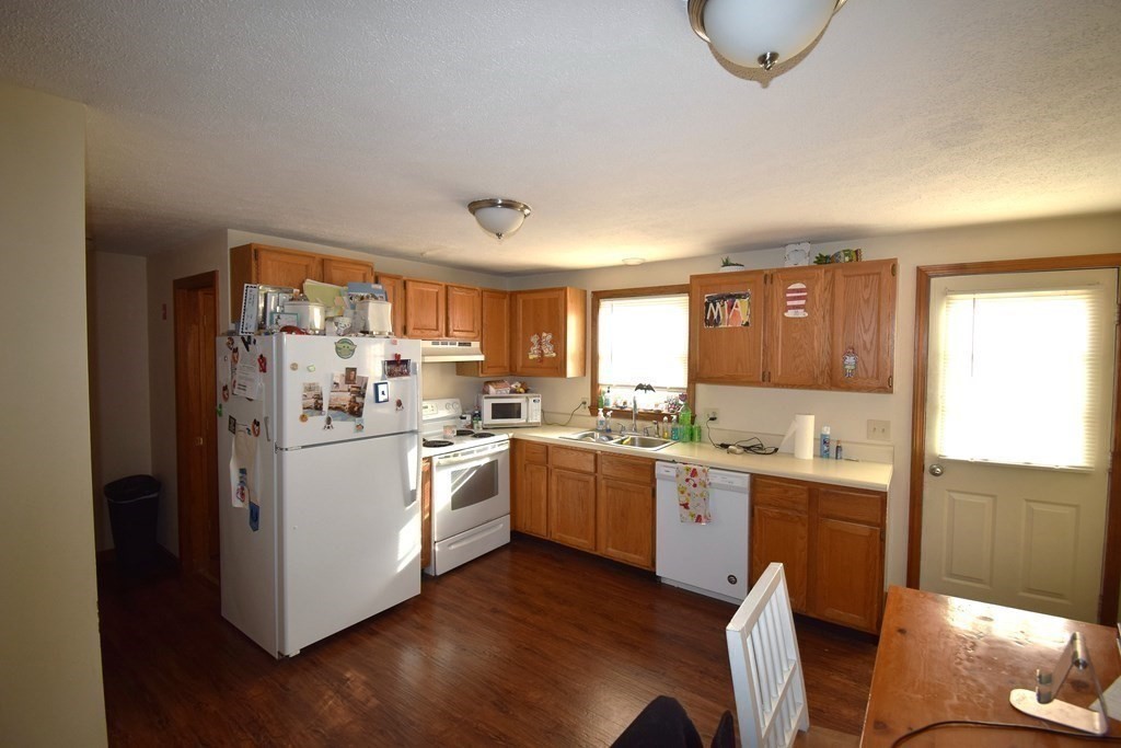 230 Chester Road Fremont, NH 03044 - Photo 8 of 30 a kitchen with a stove a sink and a refrigerator