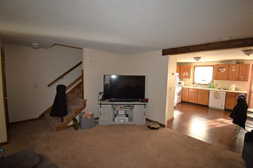 230 Chester Road Fremont, NH 03044 - Photo 9 of 30 a view of a livingroom with furniture and a flat screen tv