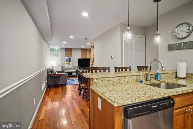 a kitchen with a stove and a view of living room