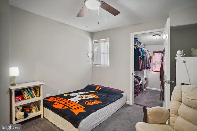 a living room with furniture and a baby crib