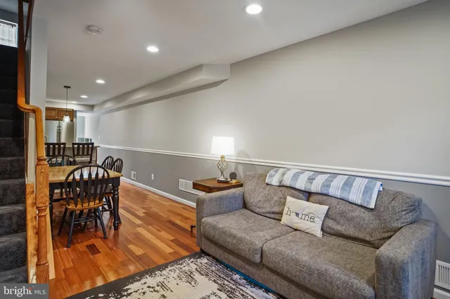 a living room with furniture and wooden floor