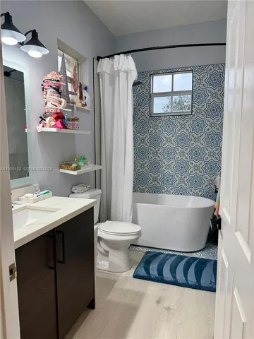 a bathroom with a bathtub sink and toilet