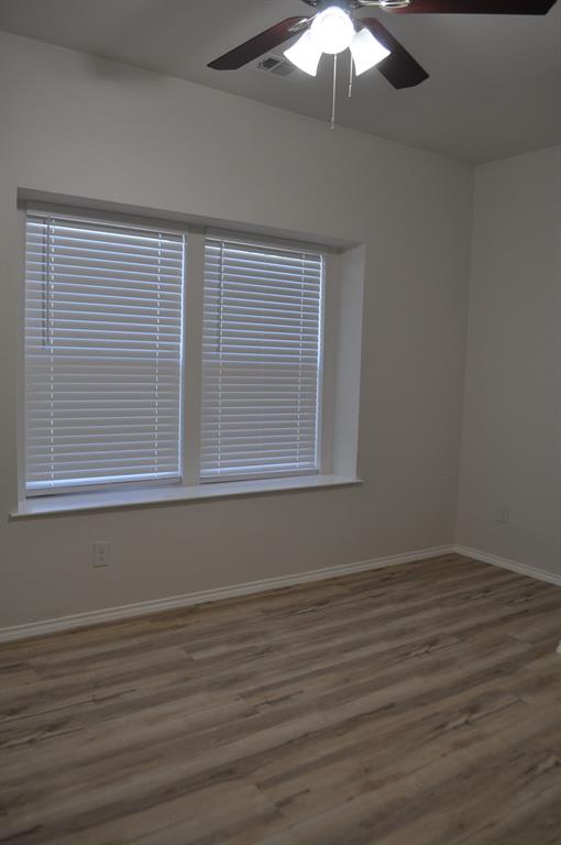 2321 Murphy Court Red Oak, TX 75154 - Photo 10 of 21 wooden floor in an empty room with a window