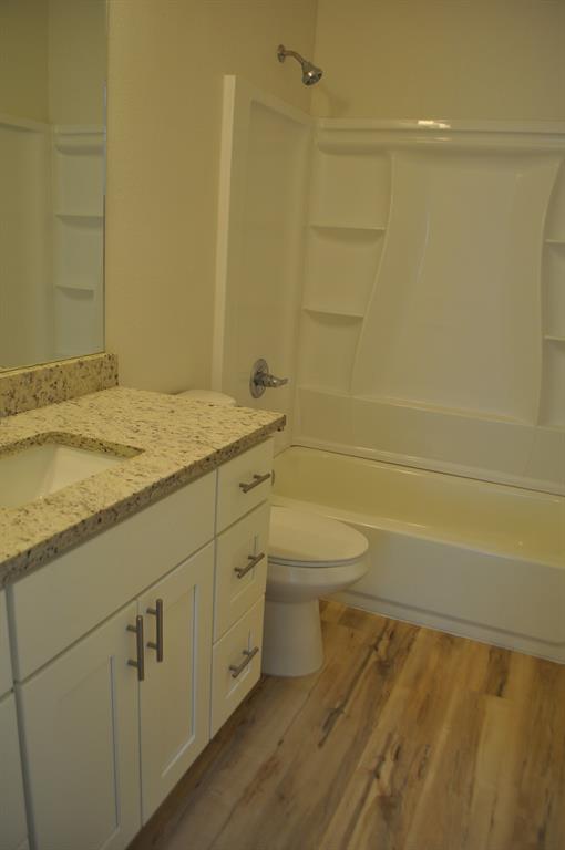 2321 Murphy Court Red Oak, TX 75154 - Photo 13 of 21 a bathroom with a granite countertop toilet and a sink