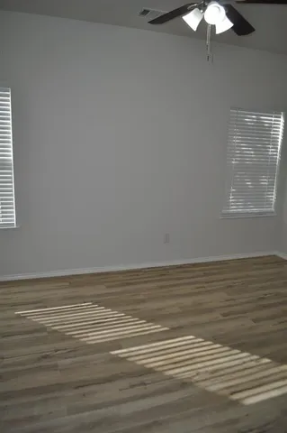 a bathroom with a granite countertop toilet and a sink