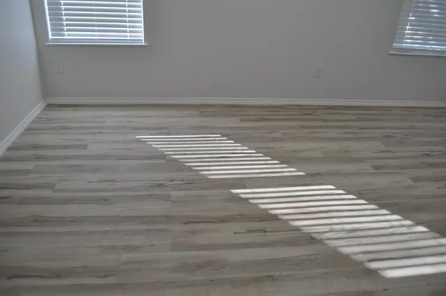 a view of a room with wooden floor and a chandelier