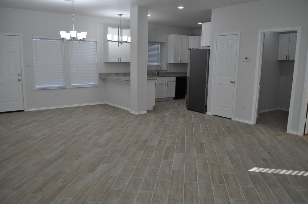 2321 Murphy Court Red Oak, TX 75154 - Photo 21 of 21 a view of a kitchen with refrigerator and wooden floor