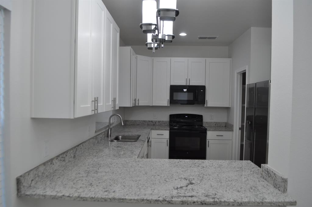 2321 Murphy Court Red Oak, TX 75154 - Photo 4 of 21 a kitchen with granite countertop a refrigerator stove and sink