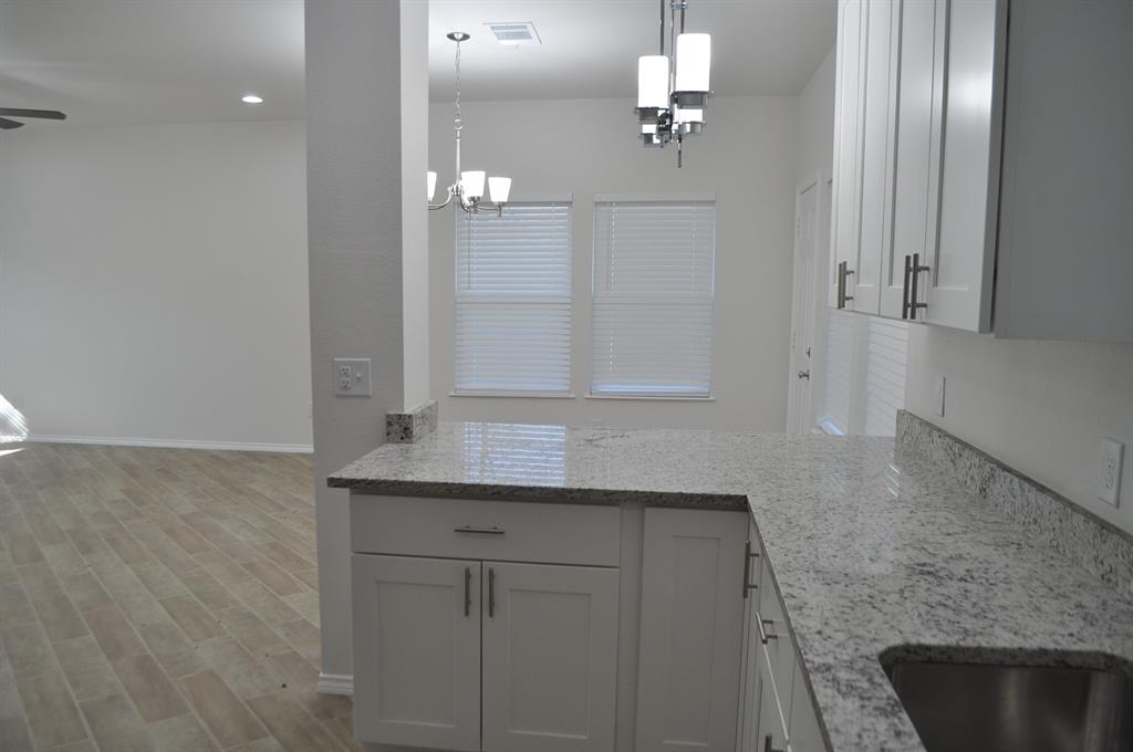 2321 Murphy Court Red Oak, TX 75154 - Photo 5 of 21 a bathroom with a granite countertop sink a mirror and vanity