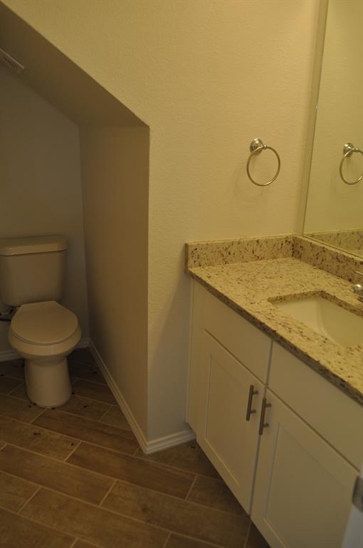 2321 Murphy Court Red Oak, TX 75154 - Photo 7 of 21 a bathroom with a granite countertop toilet and a sink