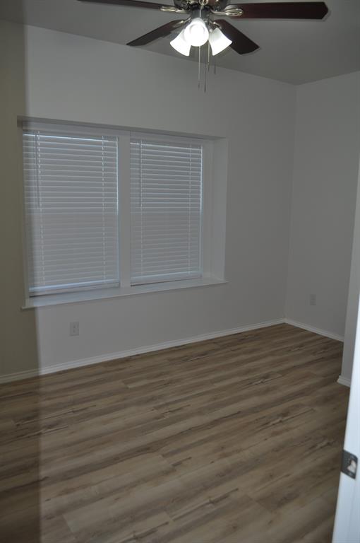 2321 Murphy Court Red Oak, TX 75154 - Photo 9 of 21 a view of an empty room with wooden floor and fan