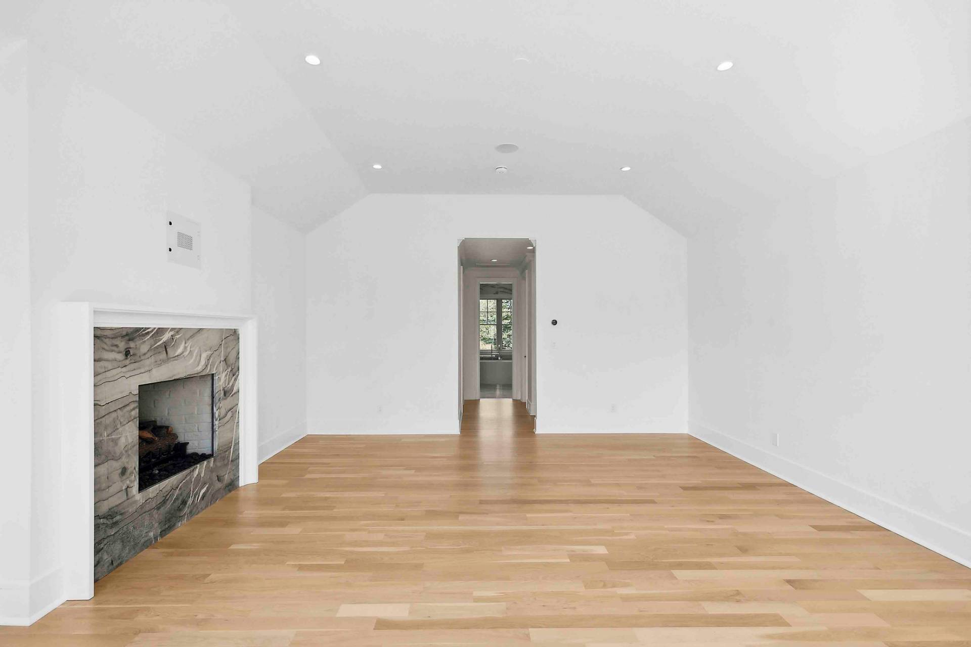 10 Cedar Lane Westhampton, NY 11977 - Photo 11 of 29 a view of an empty room with wooden floor and a fireplace
