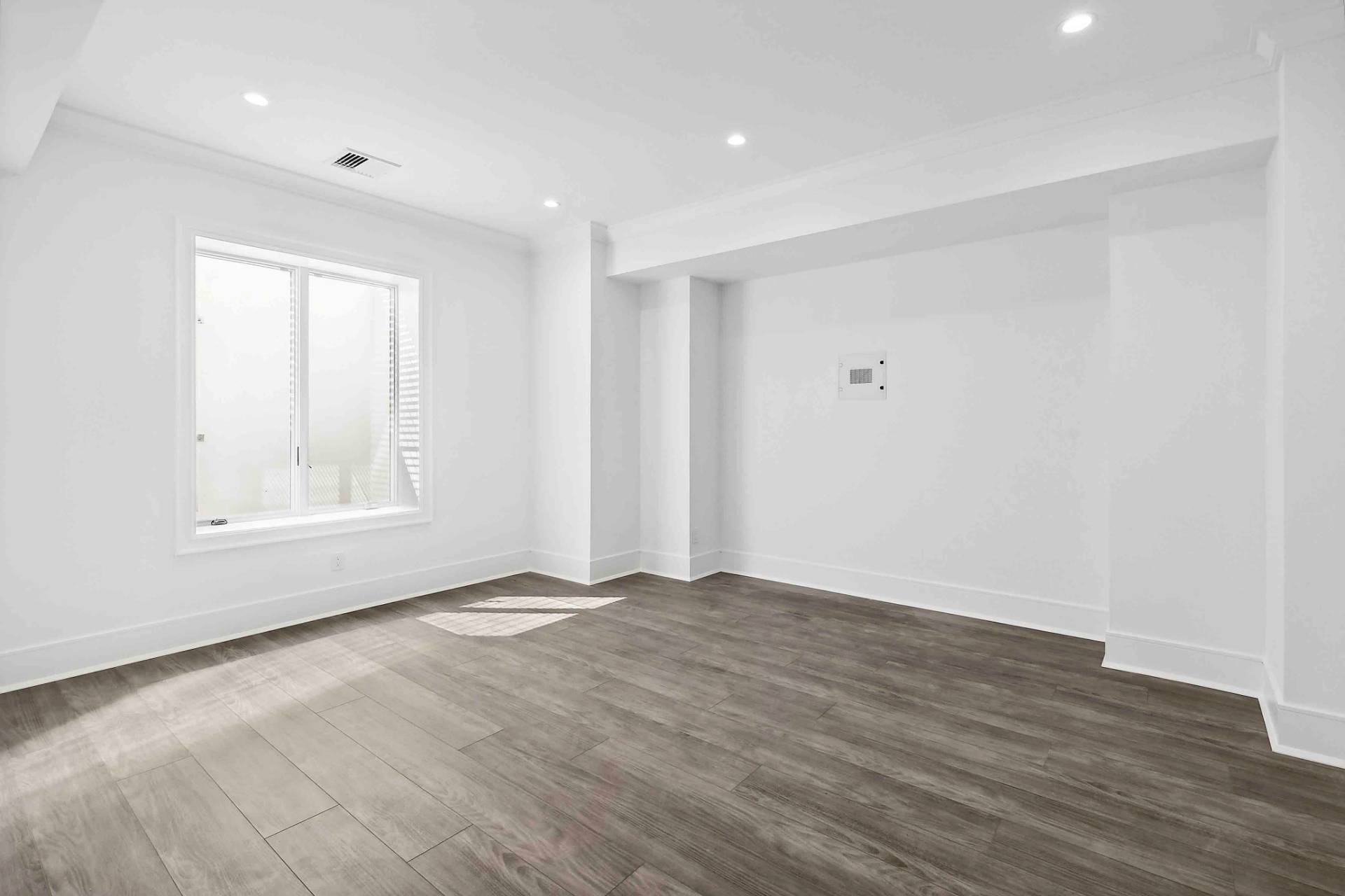 10 Cedar Lane Westhampton, NY 11977 - Photo 19 of 29 a view of an empty room with wooden floor and a window