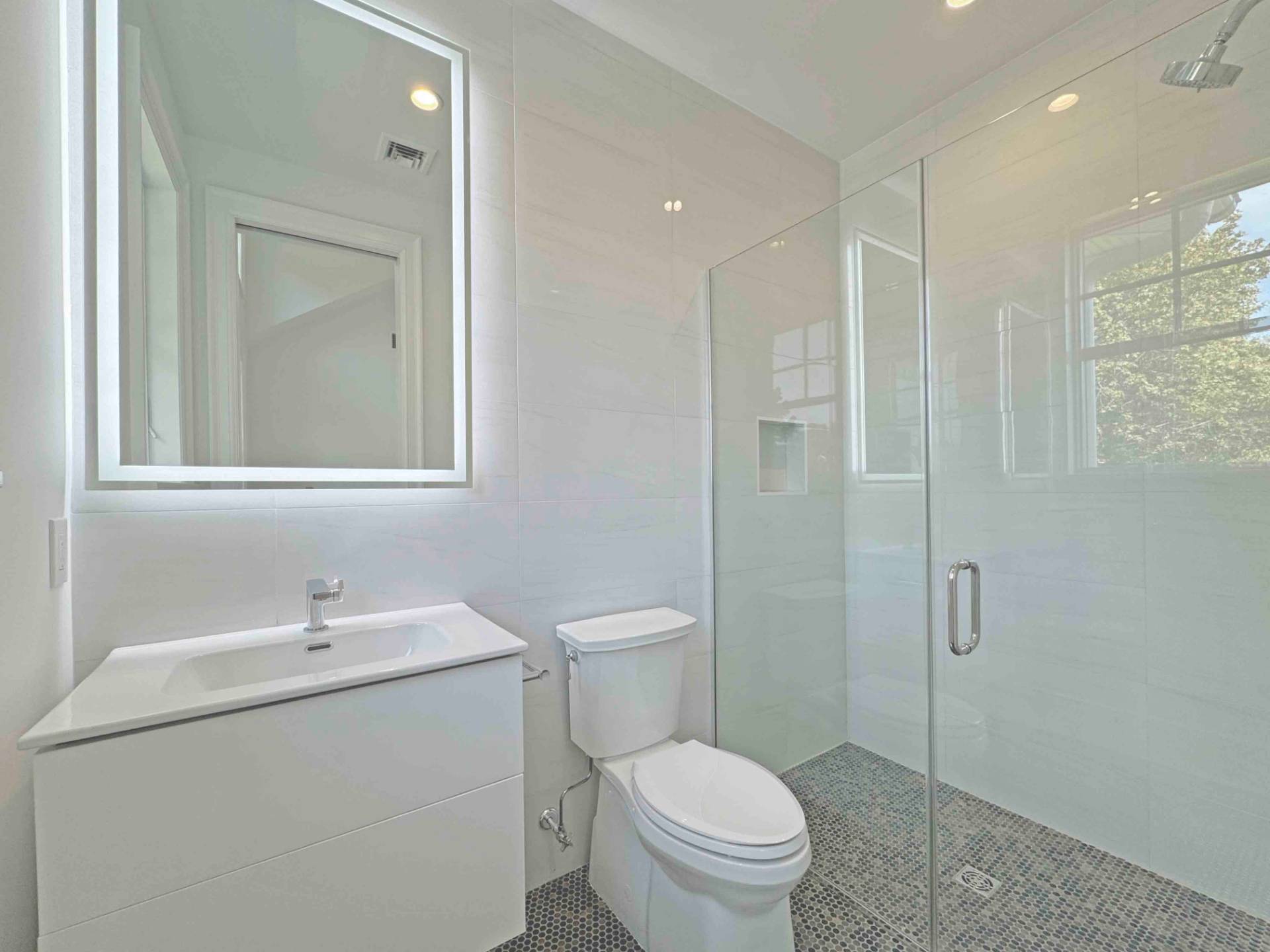 10 Cedar Lane Westhampton, NY 11977 - Photo 24 of 29 a bathroom with a toilet sink vanity and shower