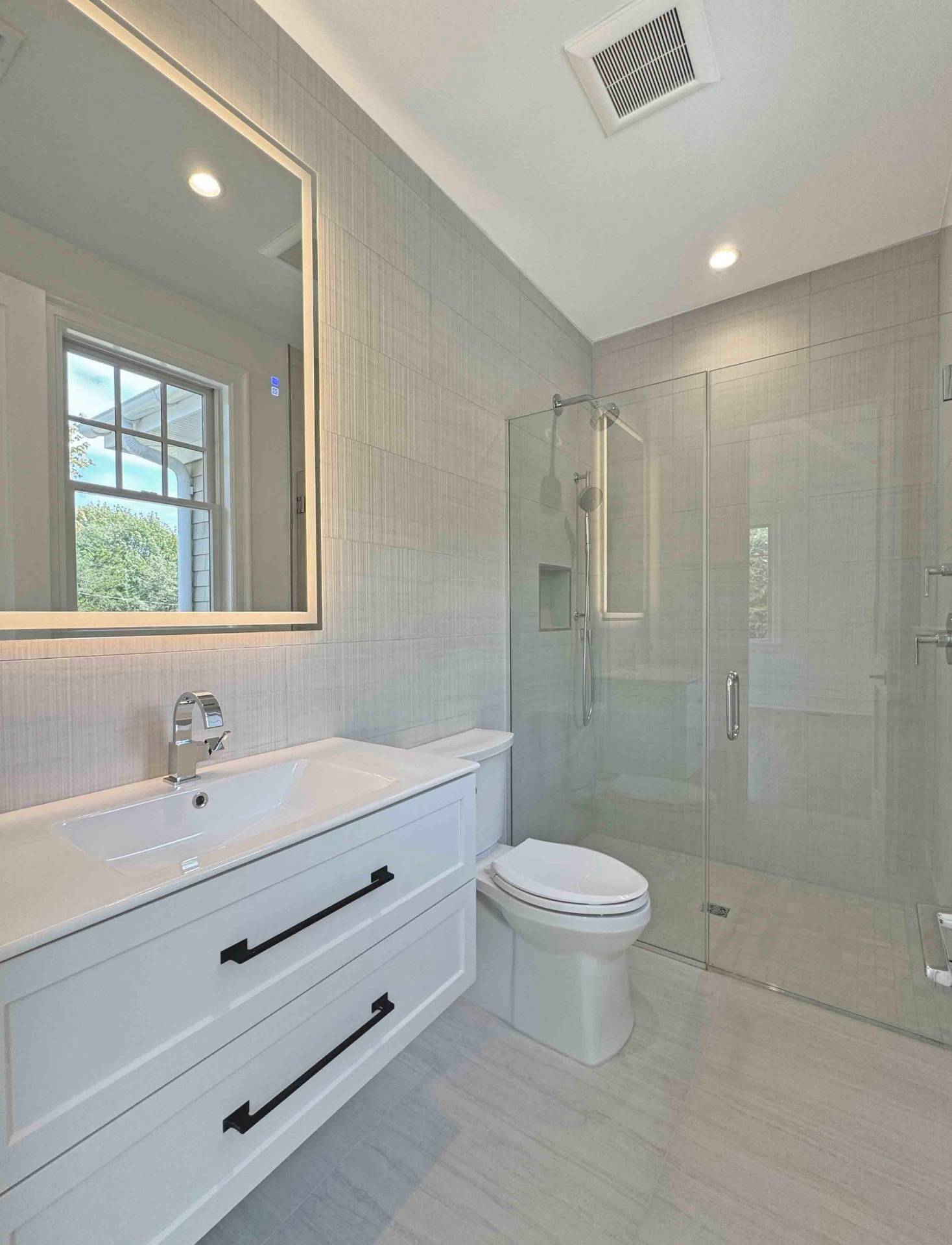 10 Cedar Lane Westhampton, NY 11977 - Photo 27 of 29 a bathroom with a double vanity sink toilet and shower