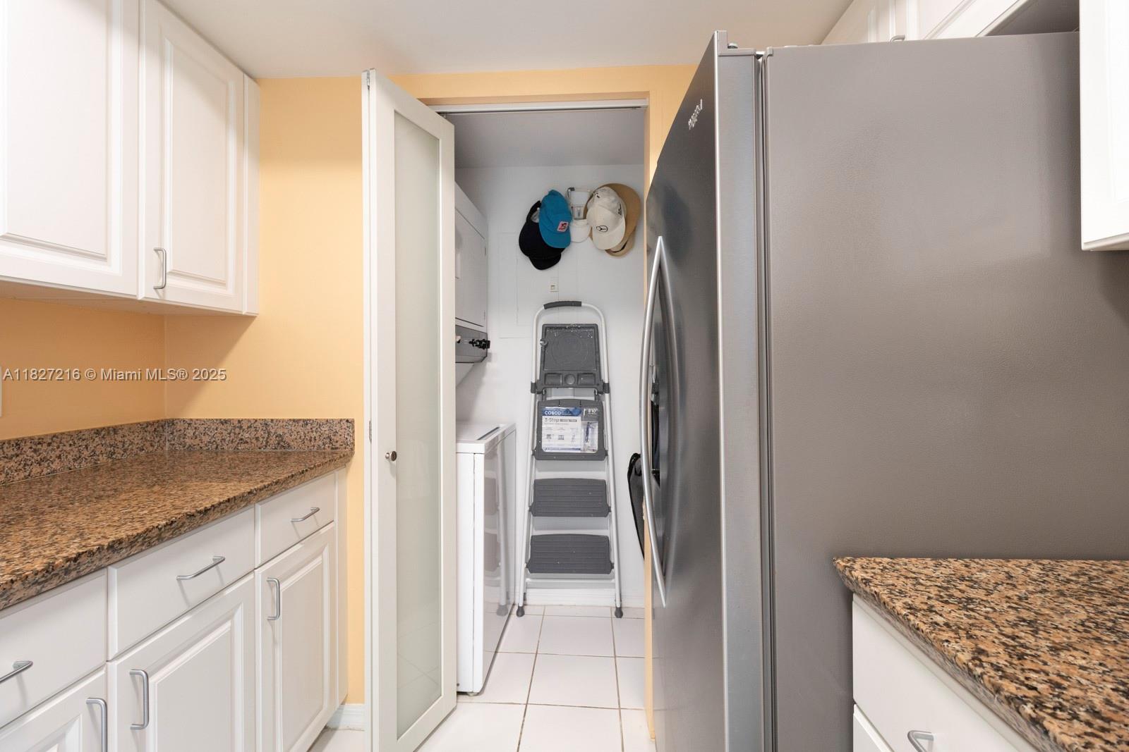 90 Alton Road, Unit 1005 Miami Beach, FL 33139 - Photo 15 of 22 a kitchen with stainless steel appliances granite countertop a refrigerator and a sink