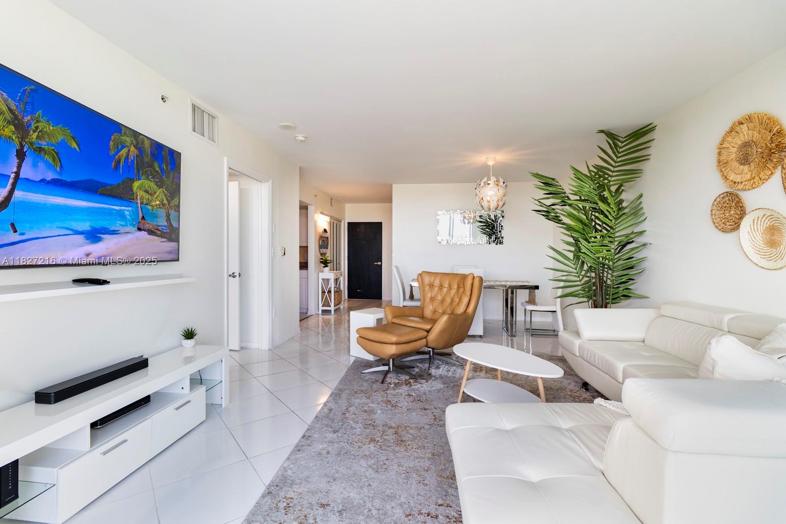 90 Alton Road, Unit 1005 Miami Beach, FL 33139 - Photo 6 of 22 a living room with furniture and wooden floor
