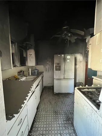 a large kitchen with a stove and a refrigerator