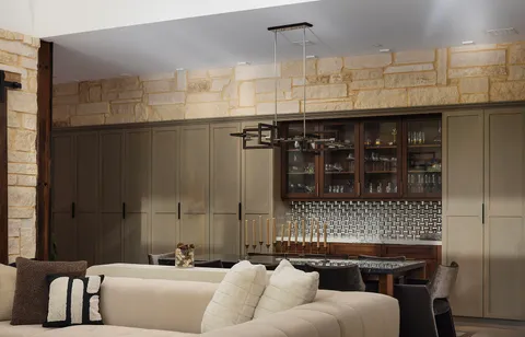 a living room with furniture and a floor to ceiling window