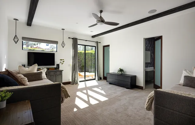a view of a backyard with plants and patio