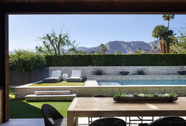 a dining room with furniture a large window and a chandelier