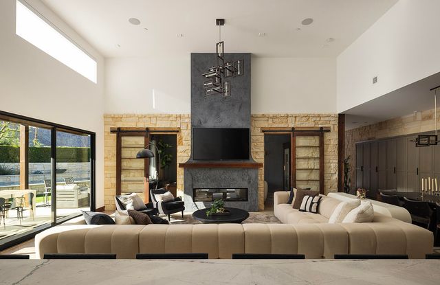 a living room with furniture or couch and a chandelier